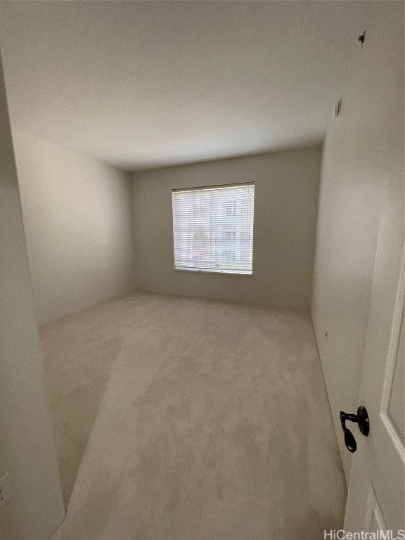 empty room featuring light colored carpet