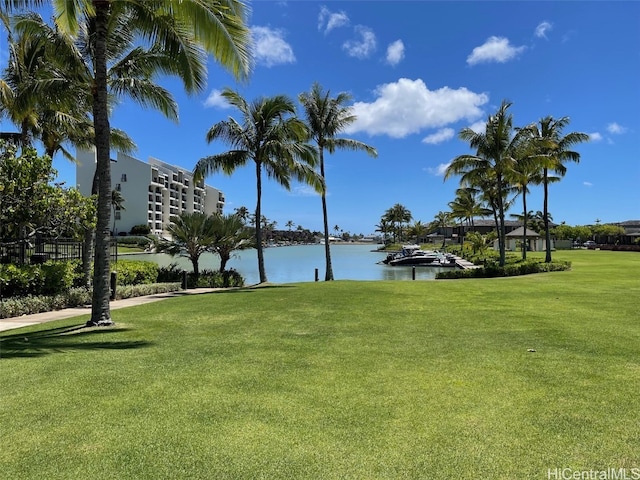 view of community featuring a water view and a yard