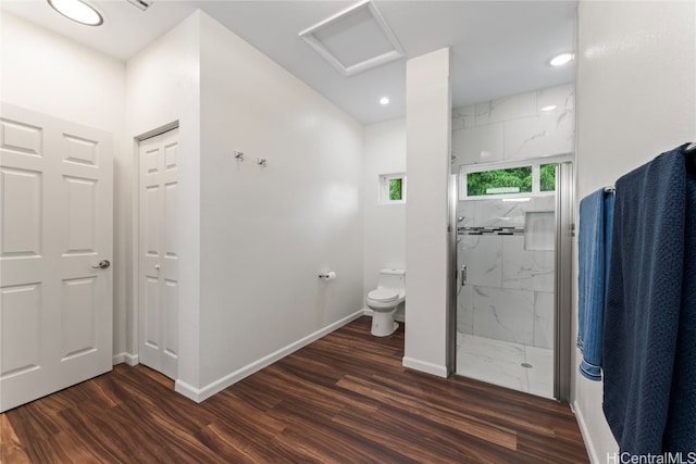 bathroom featuring wood-type flooring, toilet, and an enclosed shower