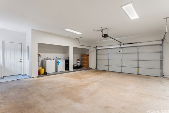 garage with a garage door opener and washing machine and clothes dryer