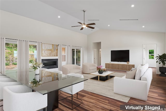 living room with ceiling fan, dark wood-type flooring, and high vaulted ceiling