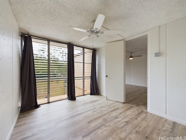 spare room with light hardwood / wood-style flooring, a textured ceiling, and ceiling fan