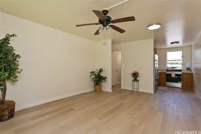 interior space with light hardwood / wood-style flooring and ceiling fan