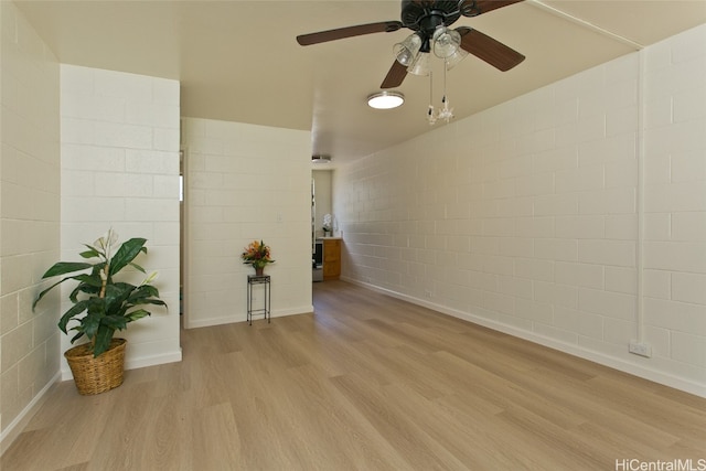 spare room with ceiling fan and light wood-type flooring