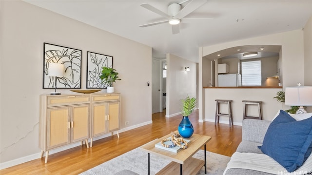 living room featuring hardwood / wood-style flooring and ceiling fan