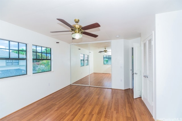 unfurnished bedroom featuring wood-type flooring and ceiling fan