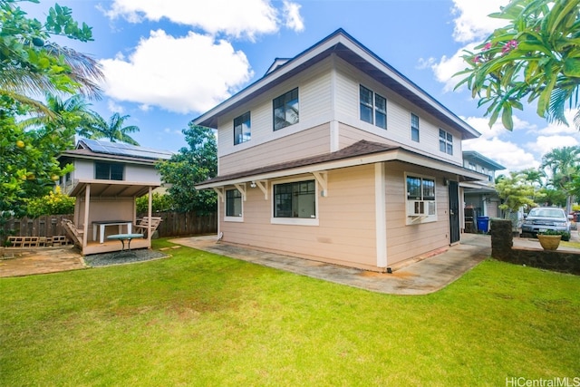 rear view of property featuring a patio, cooling unit, and a yard