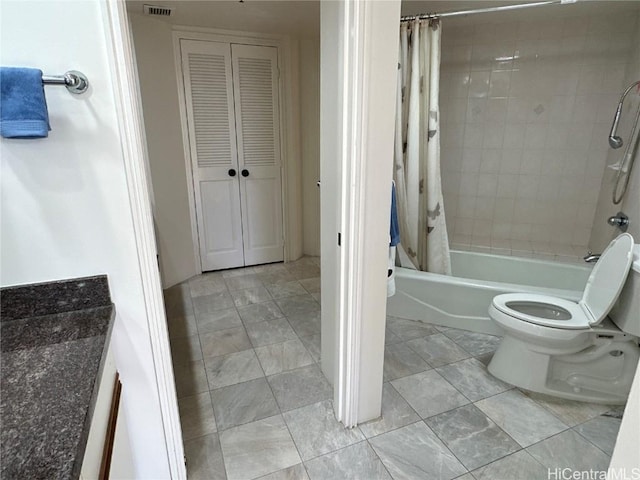 bathroom featuring shower / bathtub combination with curtain and toilet