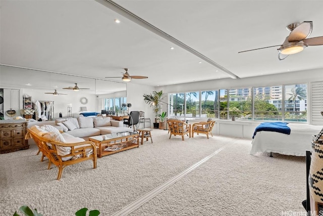 living room with ceiling fan and carpet flooring