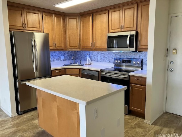 kitchen featuring a center island, sink, a textured ceiling, appliances with stainless steel finishes, and tasteful backsplash