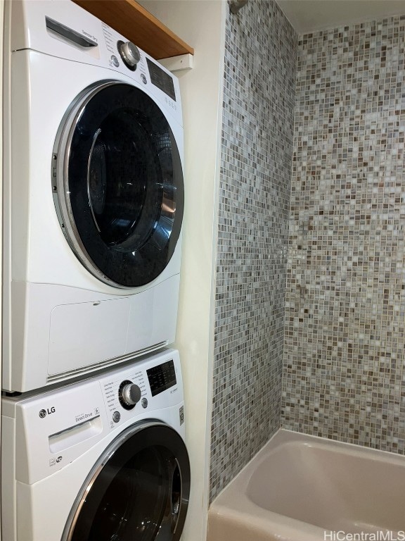 laundry room with stacked washing maching and dryer