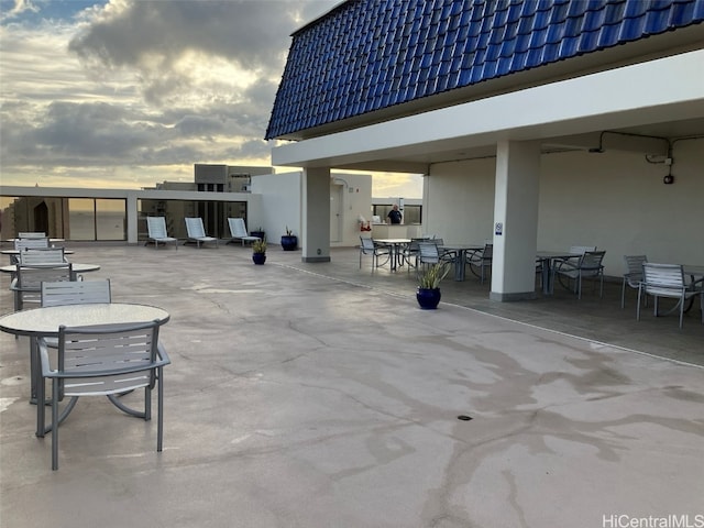 view of patio terrace at dusk