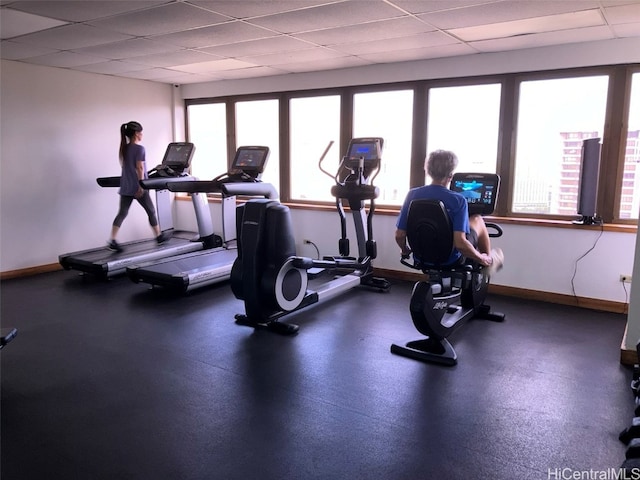 gym with a paneled ceiling