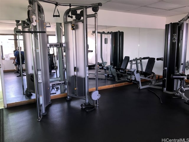 gym featuring a drop ceiling