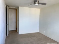 unfurnished room featuring ceiling fan and carpet floors