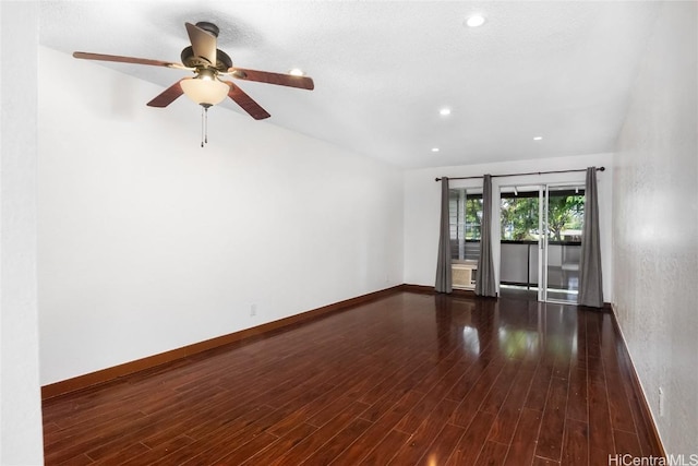 spare room with dark hardwood / wood-style floors and ceiling fan