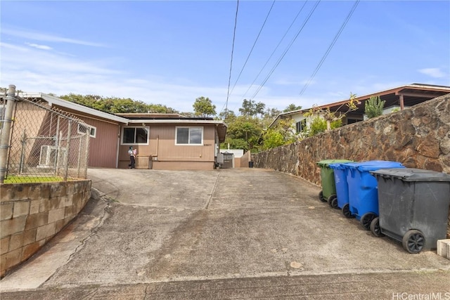 rear view of house with solar panels and fence