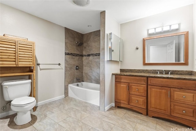 bathroom featuring vanity, toilet, baseboards, and shower / bath combination