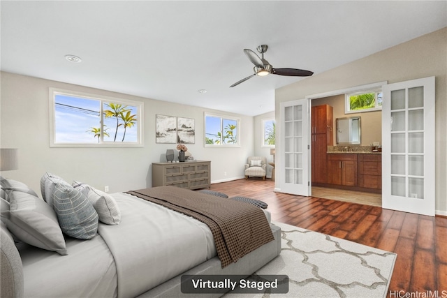 bedroom featuring connected bathroom, ceiling fan, lofted ceiling, french doors, and wood finished floors