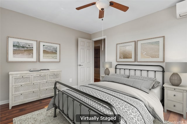 bedroom featuring dark wood-style floors, a wall mounted air conditioner, baseboards, and a ceiling fan