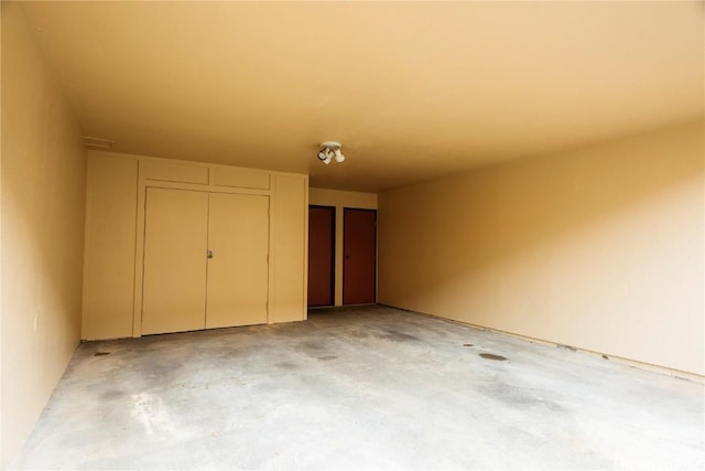 unfurnished bedroom featuring a closet and concrete floors