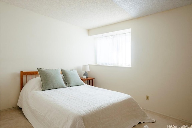 carpeted bedroom featuring a textured ceiling