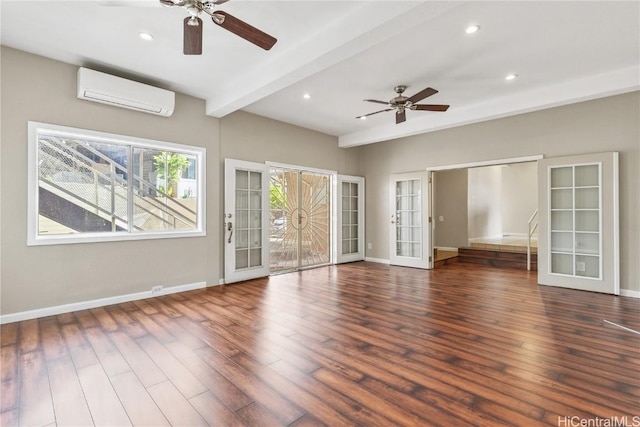 spare room with beamed ceiling, dark hardwood / wood-style flooring, french doors, and a wall mounted air conditioner