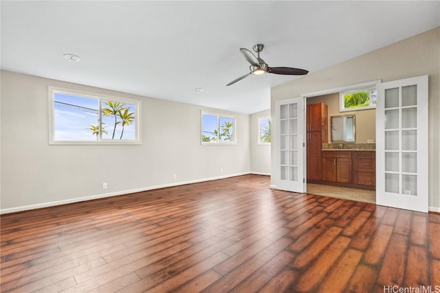 unfurnished room with ceiling fan, dark hardwood / wood-style floors, and french doors