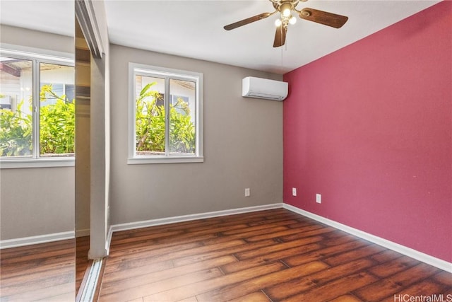 spare room featuring ceiling fan, dark hardwood / wood-style flooring, and a wall mounted air conditioner