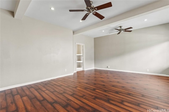 spare room with beam ceiling, built in features, and dark hardwood / wood-style floors