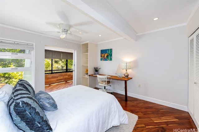 bedroom with a closet, beamed ceiling, dark wood-type flooring, crown molding, and ceiling fan