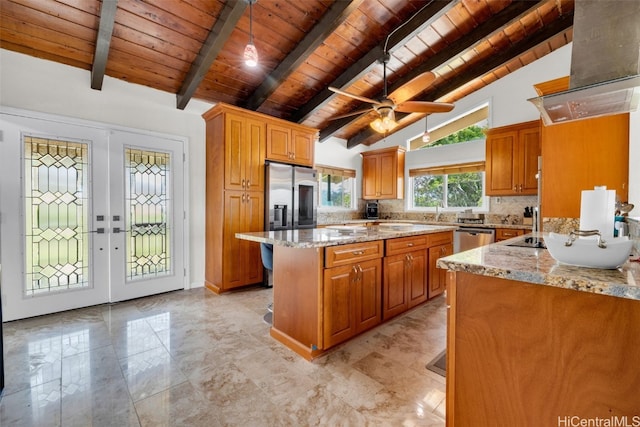 kitchen with a center island with sink, light stone countertops, wooden ceiling, beamed ceiling, and french doors