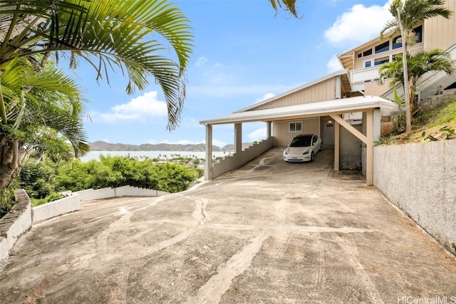 view of parking featuring a mountain view and a carport