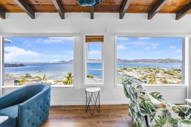 sunroom with wood ceiling, beamed ceiling, and a water view