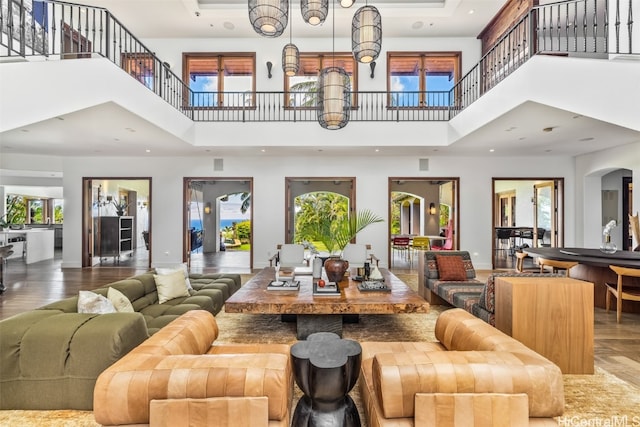 living room with hardwood / wood-style floors, a high ceiling, and a wealth of natural light