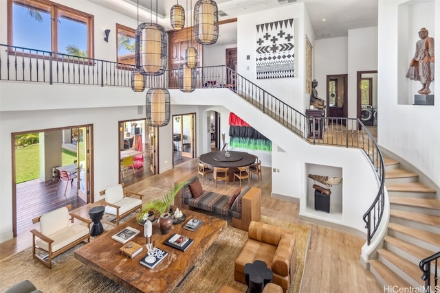 living room featuring light hardwood / wood-style floors and a high ceiling