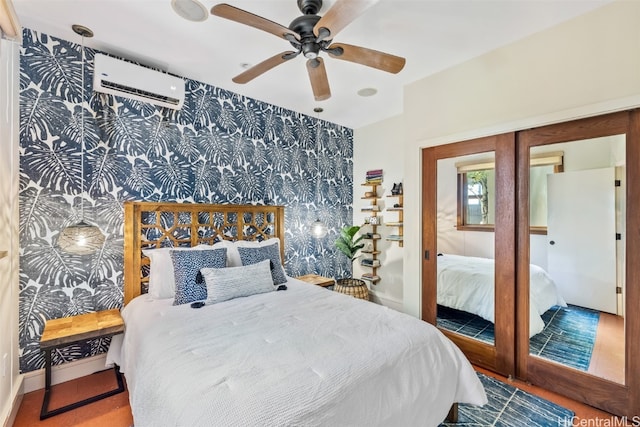 bedroom featuring french doors, a wall mounted air conditioner, and ceiling fan