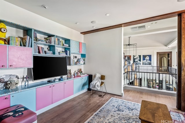 interior space featuring crown molding and hardwood / wood-style flooring