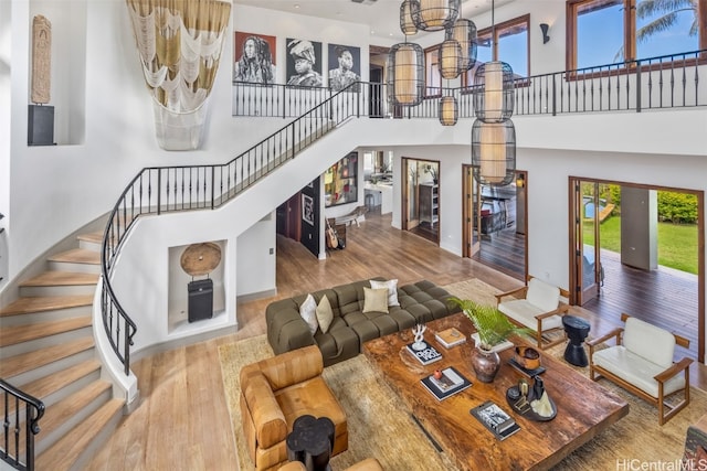 living room featuring a towering ceiling and hardwood / wood-style floors