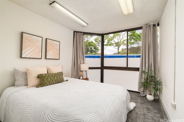 carpeted bedroom with a textured ceiling