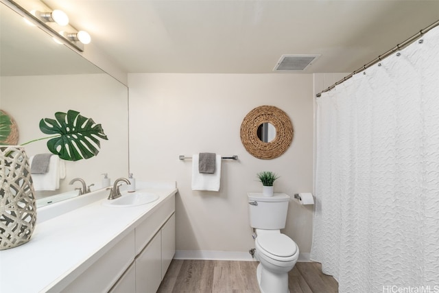 bathroom featuring vanity, toilet, and wood-type flooring