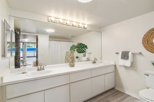 bathroom with vanity, curtained shower, wood-type flooring, and toilet