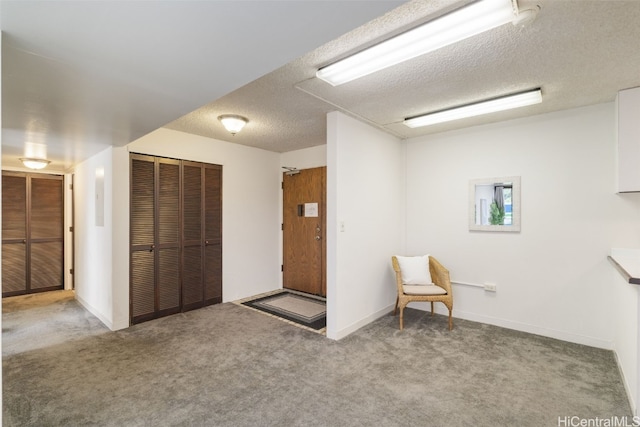 unfurnished room featuring carpet floors and a textured ceiling