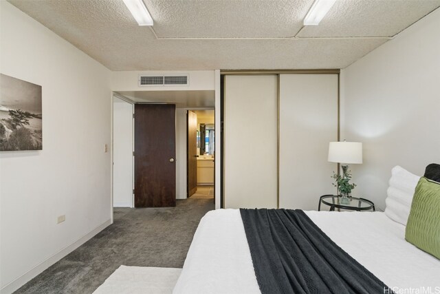 carpeted bedroom featuring a closet, a textured ceiling, and ceiling fan