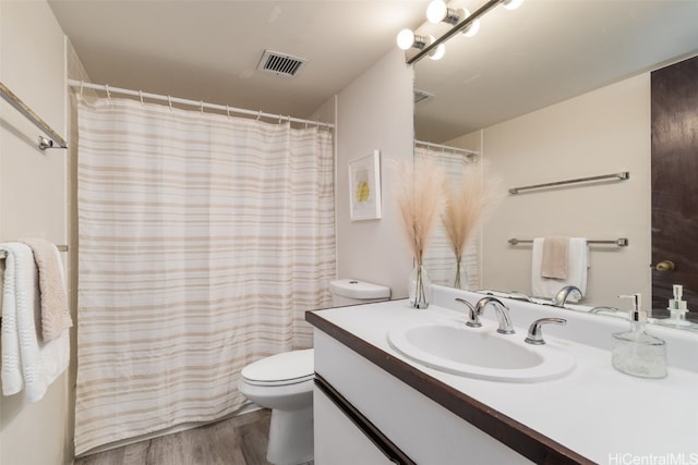 bathroom with vanity, hardwood / wood-style floors, curtained shower, and toilet