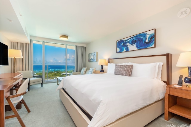 carpeted bedroom with floor to ceiling windows and access to exterior