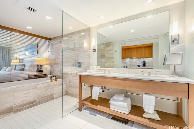 bathroom with vanity, tile patterned floors, and plus walk in shower