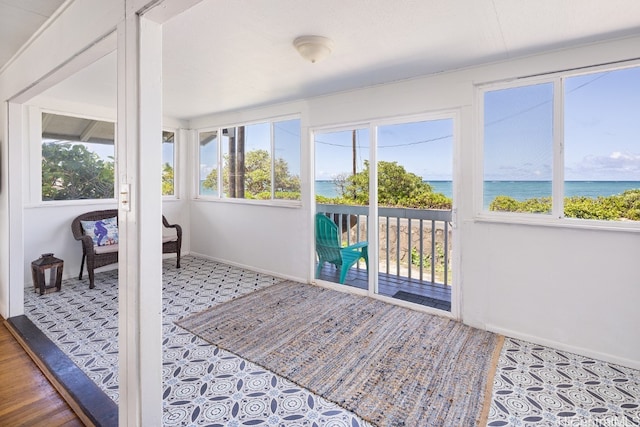 sunroom with a wealth of natural light and a water view