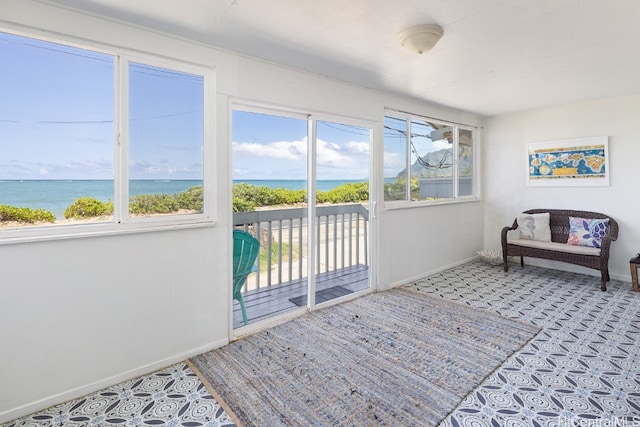 interior space with a water view and plenty of natural light