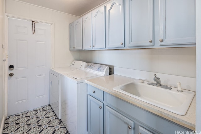 washroom with independent washer and dryer, cabinets, and sink